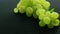 Green grapes on wet table