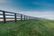 Green Grass with Black Fence Over Hill