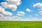 Green grass and blue sky with white clouds