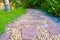 Green grass field with stone pathway and small rock decoration.