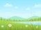 Green grass with flowers and blue lake on a mountains background