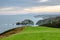 Green grass in front of the epic coast line of Asturias at Cabo