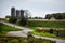 Green grass and harvest time fields along a curvy country road 3 silos