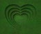 Green grass heart shape on green grass background