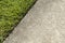 Green Grass Lawn And A Concrete Sidewalk Edge Meet