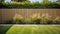 green grass lawn, plants and wooden fence in summer backyard garden