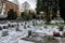 A green grass lawn with tombstones covered by snow in Lagard cemetery in winter season, Stavanger