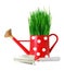 Green grass in red polka dot watering can and shovel isolated