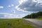 Green grass, road and blue sky