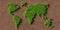 Green grass world map or globe on brown soil background, environment or ecology concept