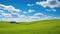 Green grassland with idyllic blue sky background