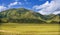 Green grassland, mountains, blue sky and white clouds