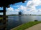 Green grassy park with small creek under a bright sunny blue sky with white fluffy clouds