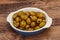 Green grilled olives in the bowl