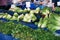 Green groceries with empty labels on the stall of a farmers market