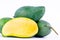 Green half mango peeled and three fresh green mangoes on white background healthy fruit food isolated