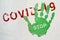 Green handprint with the inscription STOP on the inscription COVID-19. End of quarantine, reduction of viral hazard. The