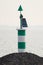 A green harbour light stand at the IJsselmeer in the Netherlands