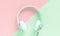 Green headphone and black cable isolated on  green and pink background pastel