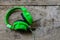 Green headphone on wooden table