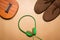 Green headphones, ukulele and boots on brown paper background