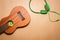 Green headphones and ukulele on a brown paper background