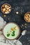 Green healthy cream soup with broccoli, crackers, cashew, parsley