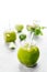 Green healty drink in two mason jars with green apple, mint and lime on white background. Vegetarian food concept. Detox