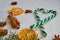 Green heart of candy cones with spices - anise stars, dried oranges, cinnamon sticks on the white background. Christmas candies