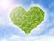 Green heart made of green leaves, symbol of eco friendly with green banner and blue sky