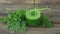 Green herb smoothie on wooden brown table