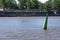 Green high buoy under water for ships and boats