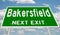 Green highway sign for Bakersfield next exit