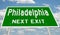 Green highway sign for Philadelphia next exit