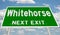 Green highway sign for Whitehorse next exit