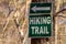 A Green Hiking Trail Sign In The Woods