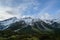 Green hill range with snow on mountain peak in New Zealand