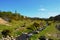 Green hill and a water stream in Bodmin Moor area near old mining shaft