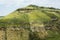 Green Hills with Blooming Wild Flowers and Rural Path in Spring. Viewpoint of Pure Nature Hiking Trail.