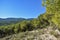 Green hills and blue skies and a sandy clearing