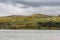 Green hills and farm at Loch Kylesku, Scotland.