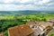 Green hills and pastures of Tuscany and rooftops of Montepulciano town, located on top of a limestone ridge surrounded by