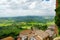 Green hills and pastures of Tuscany and rooftops of Montepulciano town, located on top of a limestone ridge surrounded by