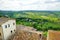 Green hills and pastures of Tuscany and rooftops of Montepulciano town, located on top of a limestone ridge surrounded by