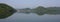 Green hills reflecting in Lake Begnas