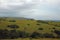 GREEN HILLS UNDER CLOUDY SKY