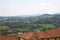 Green hills view and rooftops from panoramic viewpoint in Mondovi, Italy