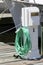 Green hose and nozzle on a pier