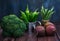 Green hot pepper in an enameled watering can, broccoli and beets on a dark wooden background