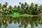 Green house in the Kerala backwaters in the lush jungle along the canal, Alappuzha - Alleppey, India